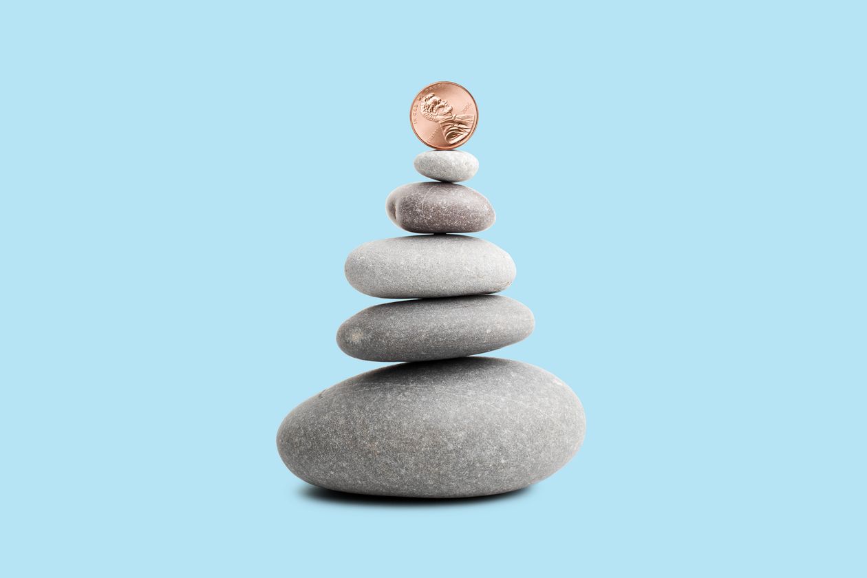 Penny balancing on top of a stack of rocks