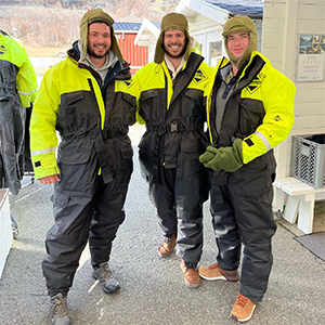 Three men posing in winter gear