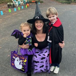 Sara with her children in Halloween costumes